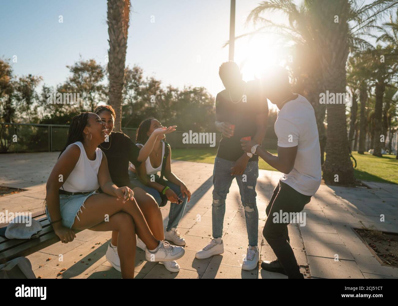 Groupe de jeunes amis noirs africains modernes heureux de s'asseoir ensemble Banque D'Images