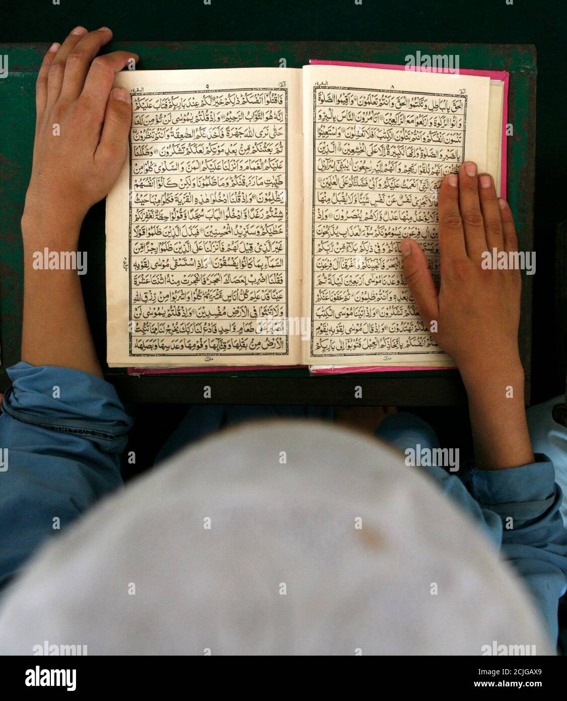 Un garçon pachtoune étudie le Coran, l'écriture sainte de l'Islam, à la Jamia Ashrafia madrasa, dans la ville frontière du Nord-Ouest du Pakistan, Peshawar, le 26 juillet 2007. REUTERS/Adrees Latif (PAKISTAN) Banque D'Images
