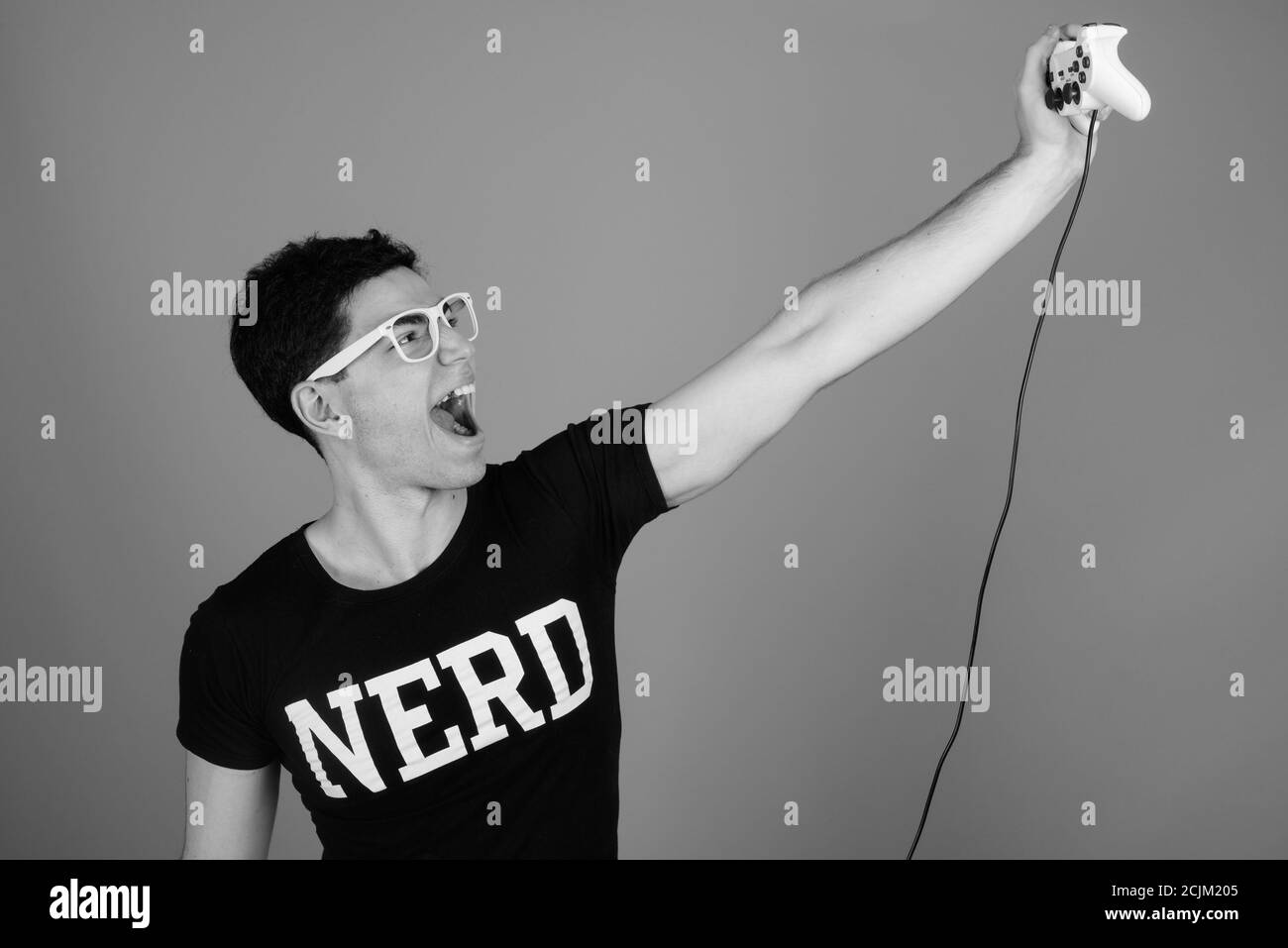 Portrait du jeune Perse nerd heureux homme jouant des jeux Banque D'Images Portrait du jeune Perse nerd heureux homme jouant des jeux Banque D'Images