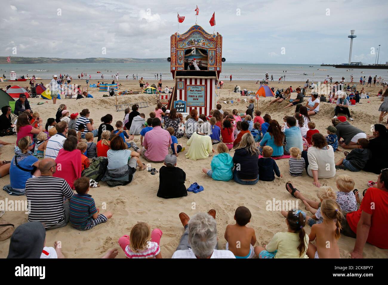 People Watch A Punch And Judy Show Performed By Professor Mark Poulton At The Seaside In Weymouth Southern England August 12 14 Poulton Is One Of The Last Professional Puppeteers Who Still