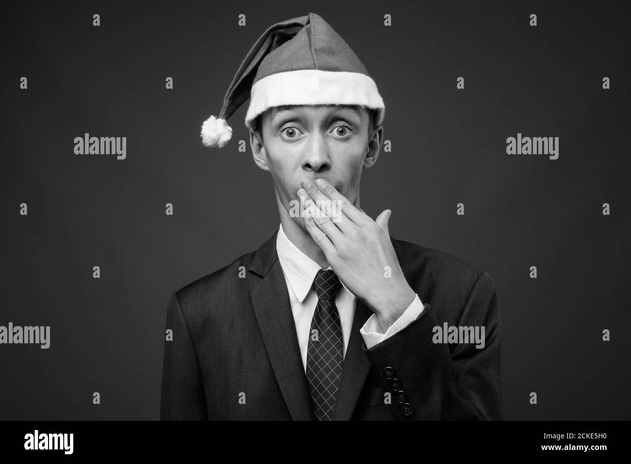 Portrait de jeune homme d'affaires avec chapeau de père Noël prêt pour Noël Banque D'Images