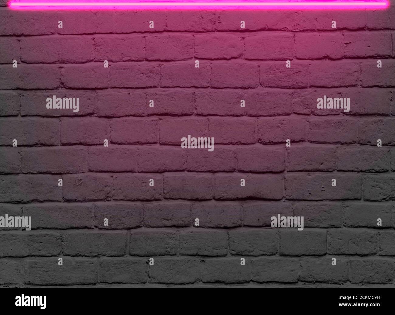 Mur de briques avec néon rose pour des idées publicitaires Banque D'Images