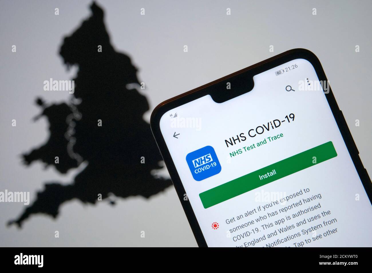 Stafford / UK - septembre 16 2020: NHS COVID-19 écran d'installation de l'application Test and Trace vu sur la silhouette du smartphone et carte floue de l'Angleterre Banque D'Images
