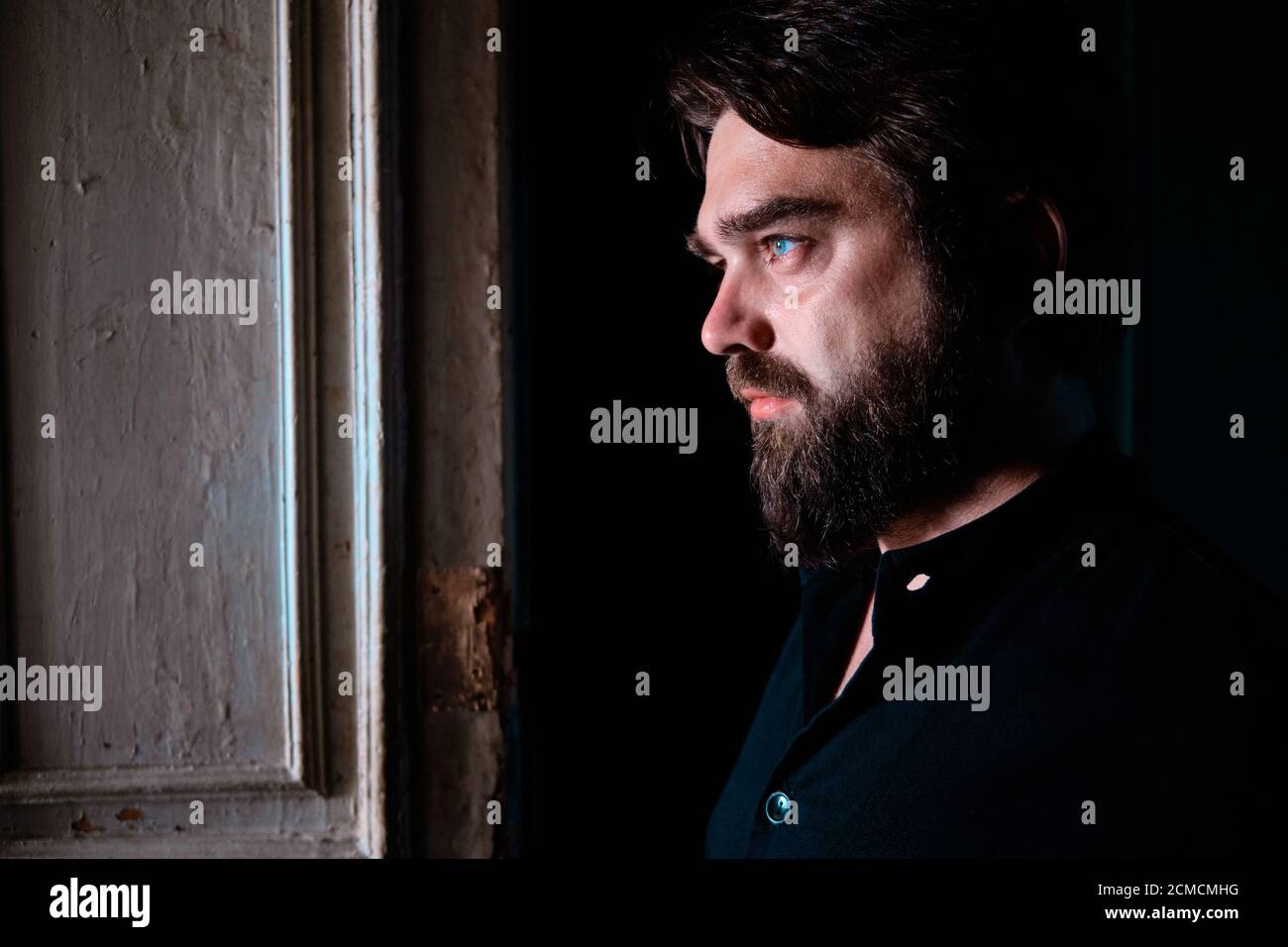 Portrait de profil de l'homme charismatique aux yeux bleus barbu Banque D'Images