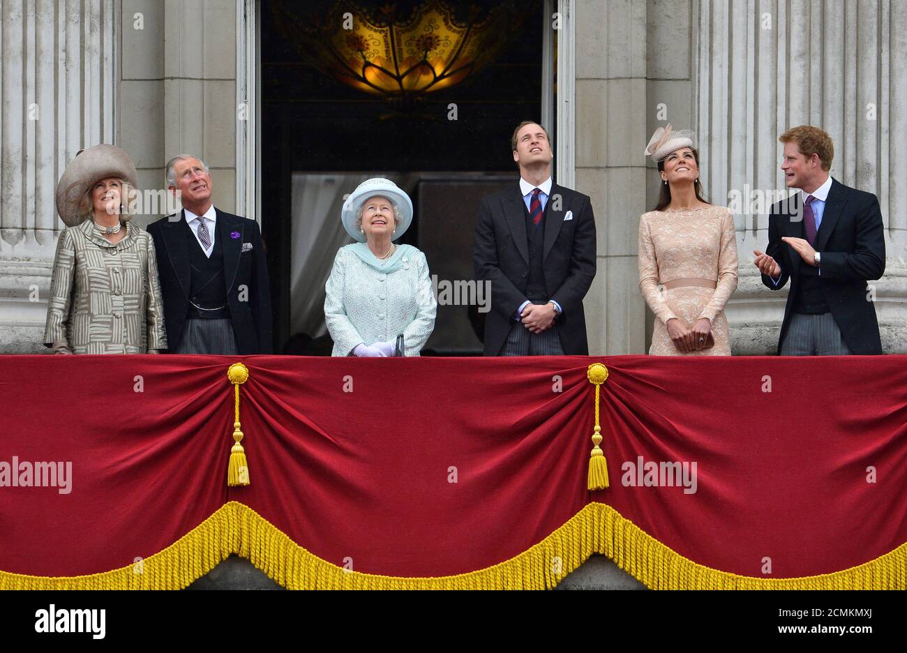 Britain's Queen Elizabeth (3rd L) looks up during a fly past as she stands  with (L-R) Camilla, Duchess of Cornwall, Prince Charles, Prince William,  Catherine, Duchess of Cambridge and Prince Harry on