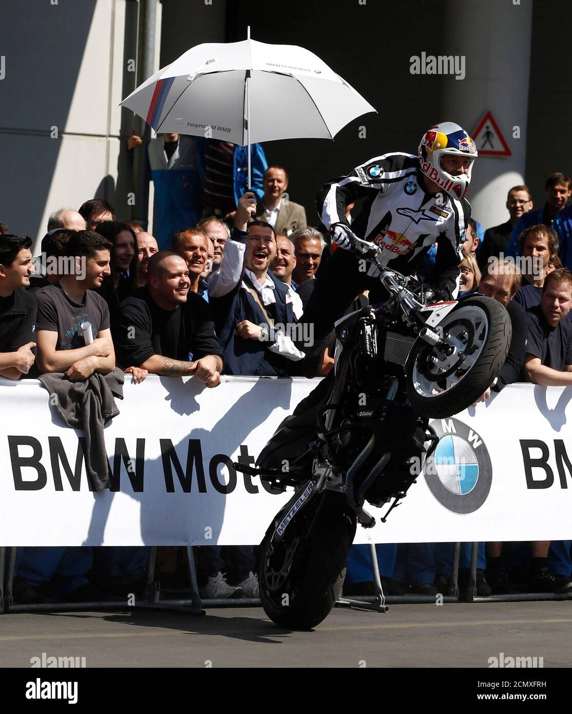 Streetbike freestyle rider Chris Pfeiffer performs with a BMW motorcycle at  the company's factory in Berlin, May 6, 2011. BMW celebrated it's two  millionth motorcycle to come off the production line at