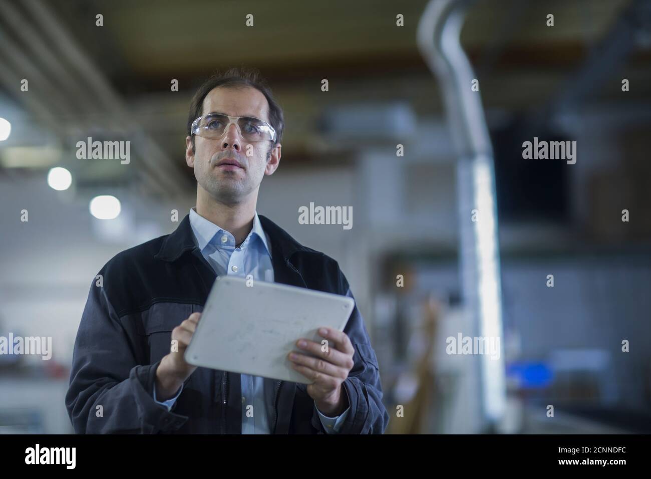 Ingénieur utilisant une tablette numérique dans une usine, l'Allemagne Banque D'Images