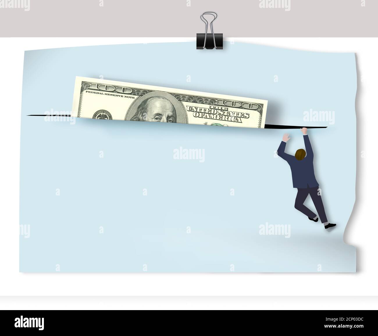 Un homme monte pour obtenir un billet de cent dollars qui est coincé dans une fente dans le matériel sur le mur. Banque D'Images