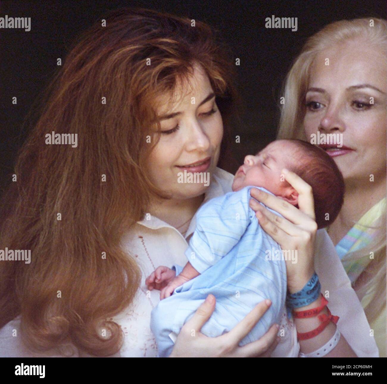 Former Mexican pop star Gloria Trevi (L) holds her newborn son Angel  Gabriel up for some morning light as her mother, Gloria Ruiz, looks on, at  Brasilia's Regional North hospital March 7,