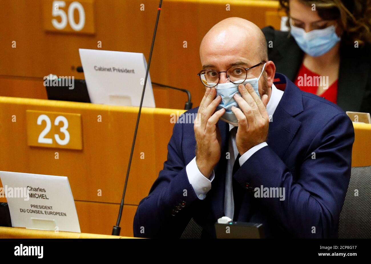 Le président du Conseil européen Charles Michel ajuste son masque lorsqu'il  assiste à un débat sur le financement de l'UE et la reprise économique avec  les législateurs de l'UE au Parlement européen