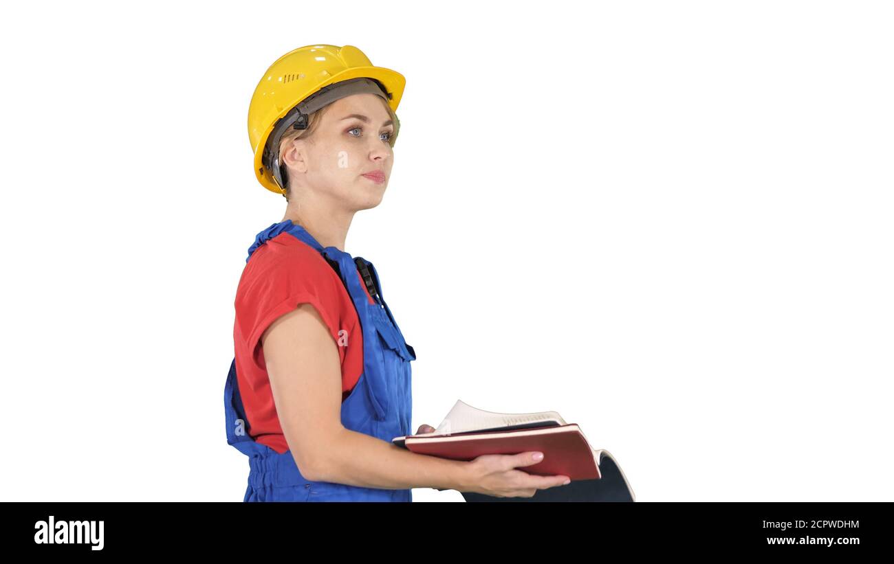 Femme travailleur de la construction en casque de sécurité et en tenue de travail contrôle uniforme Banque D'Images