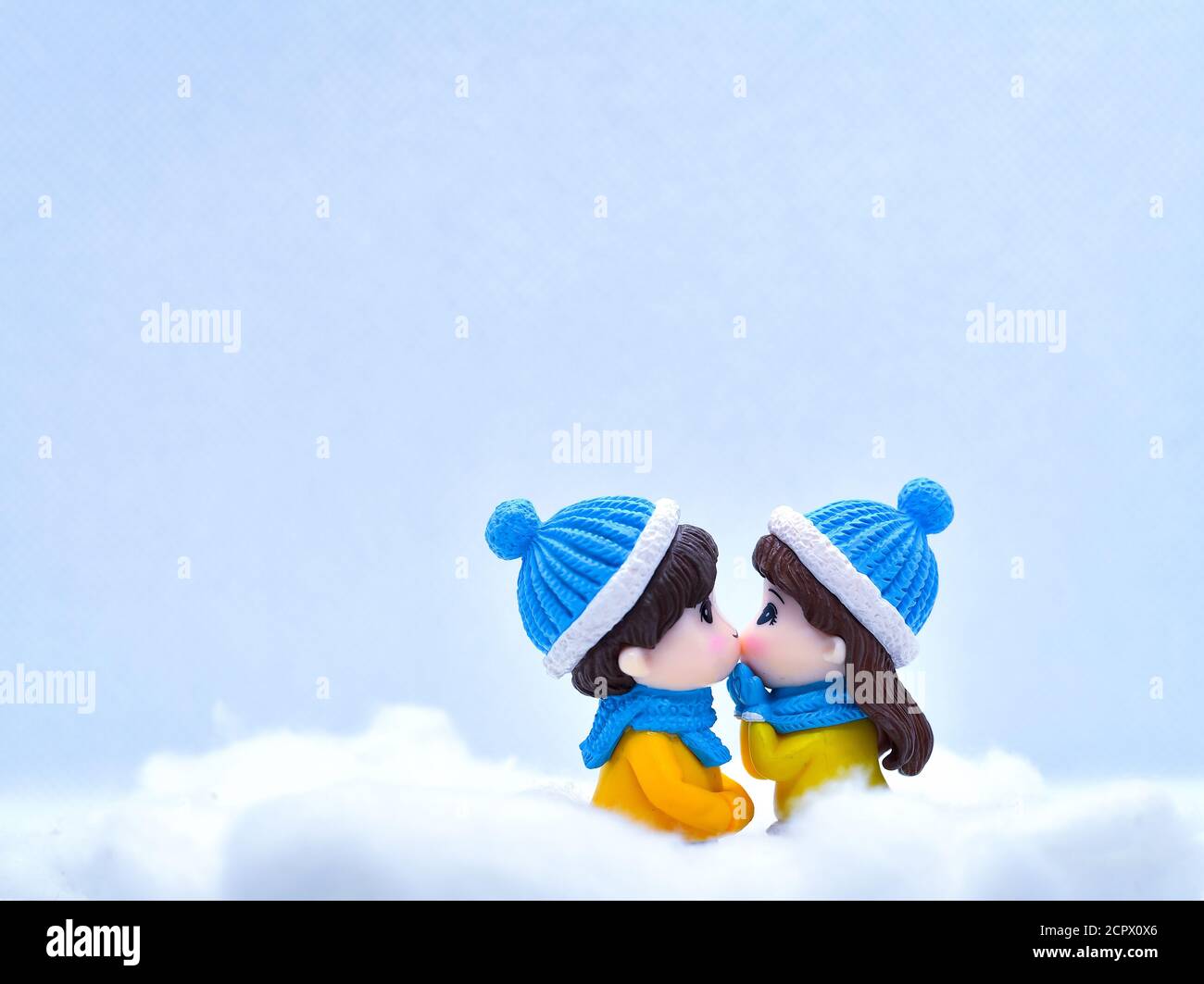Tourisme et Voyage concept: Les personnes miniatures s'embrassant dans la neige d'hiver Banque D'Images
