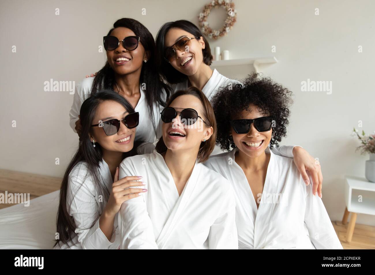 Jeune multiracial diverse fille besties dans les robes portant des lunettes de soleil sombres. Banque D'Images