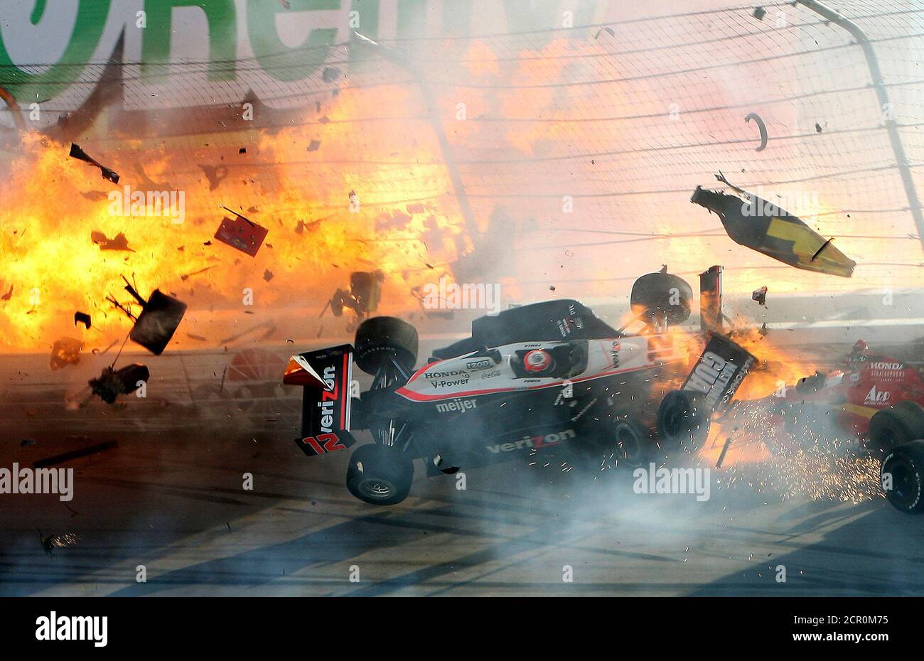 The race car of driver Will Power hits the wall as flames from British  driver Dan Wheldon's car burst (at left) during the IZOD IndyCar World  Championship race at the Las Vegas