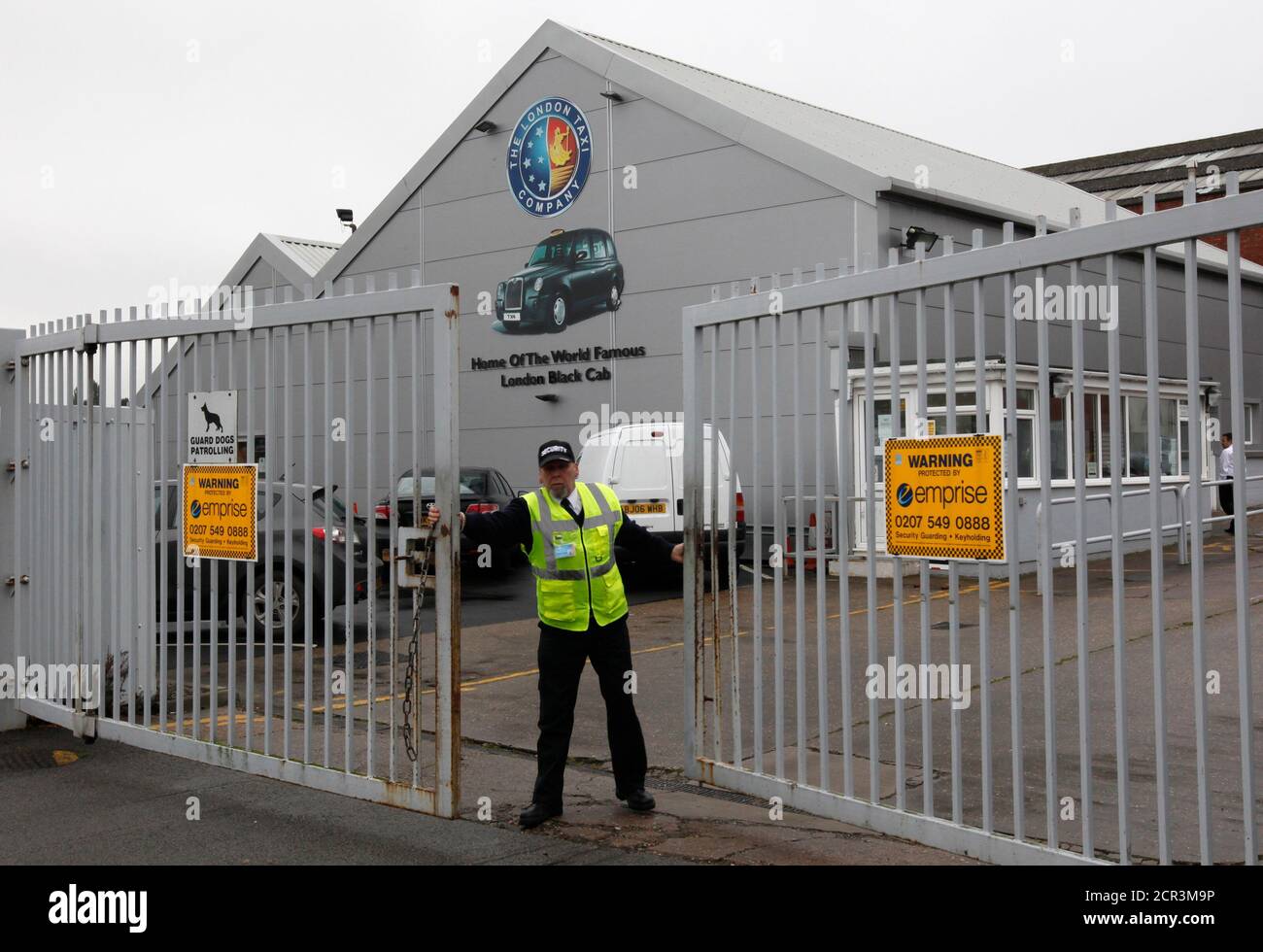 A security guard closes the main gate of the London Taxi Company in  Coventry, central England October 22, 2012. Manganese Bronze Holdings Plc,  the maker of London's iconic black cabs, said it