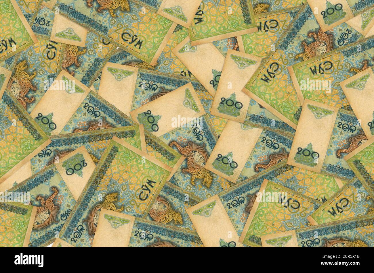 200 les factures d'ouzbek se trouvent dans une pile. Fond conceptuel riche de la vie. Beaucoup d'argent Banque D'Images