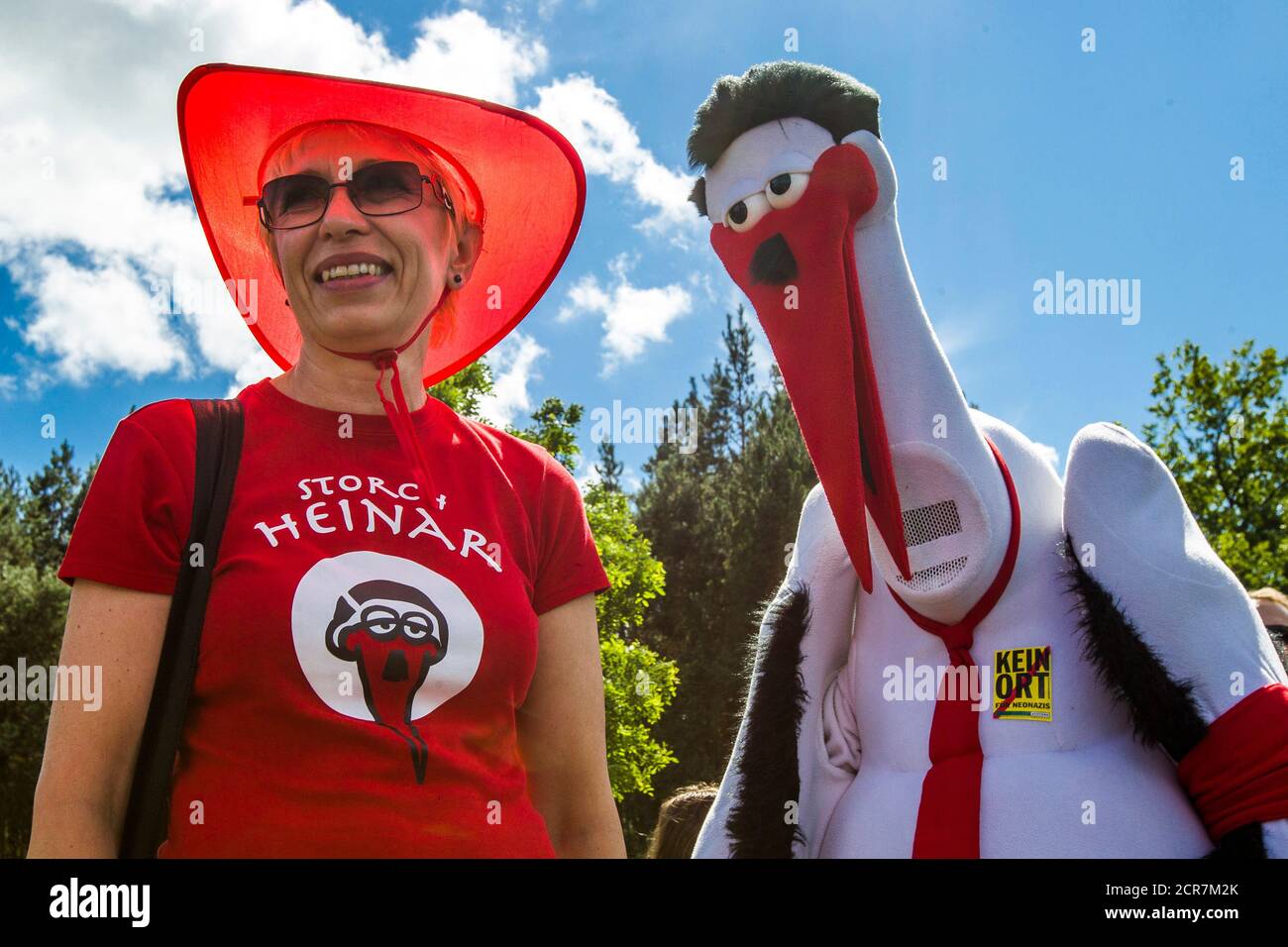 President of the Mecklenburg-Vorpommern state parliament Sylvia  Bretschneider (L) stands next to the Storch Heinar mascot during a protest  against a far-right festival outside the village of Viereck, some 130 km (81