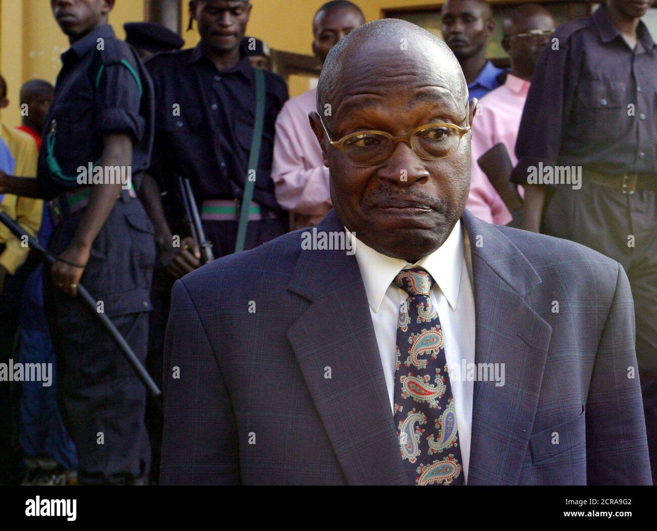 Former Rwandan president Pasteur Bizimungu, shrugs as he leaves a court  house in the capital Kigali on Monday June 7, 2004 after being sentenced to  15 years in prison for inciting ethnic