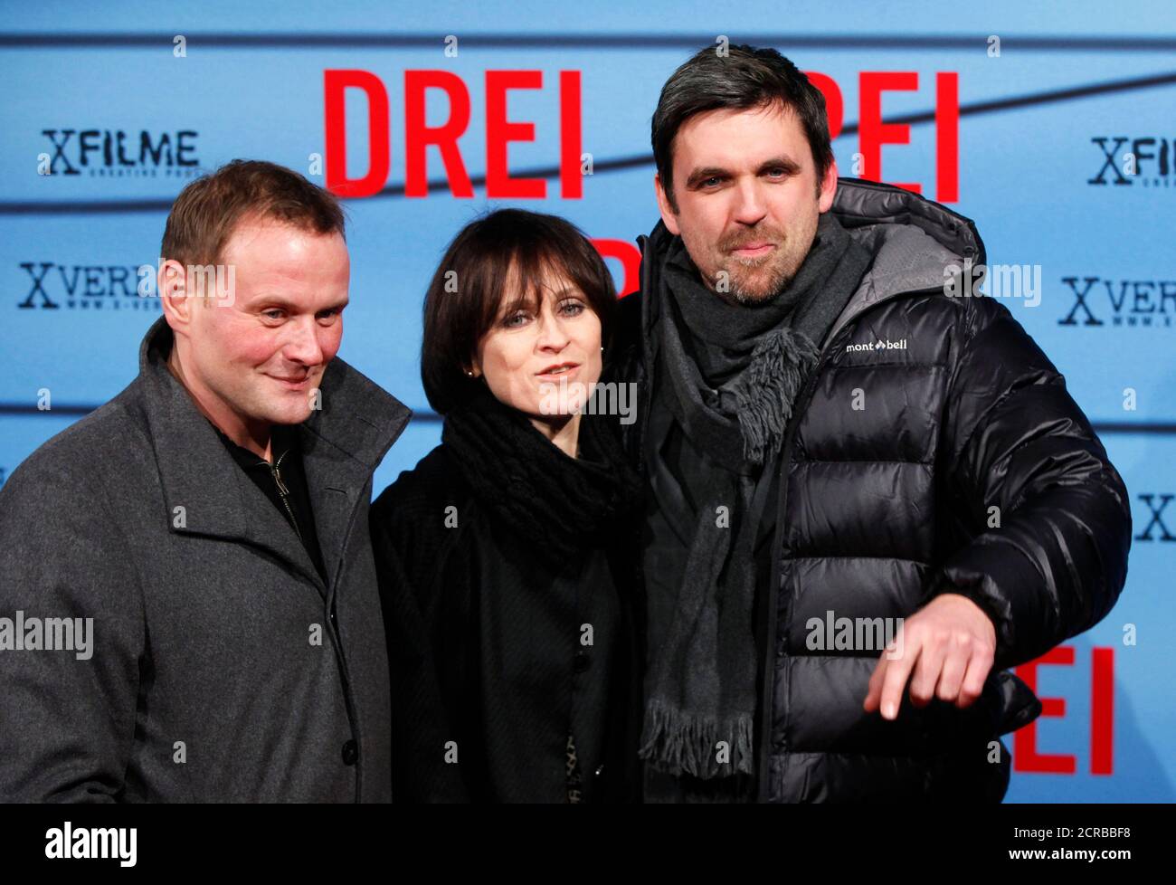 Actors Devid Striesow (L), Sophie Rois and Sebastian Schipper (R) pose for  pictures before the premiere of their movie 'Drei' (Three) in Berlin,  December 13, 2010. REUTERS/Thomas Peter (GERMANY - Tags: ENTERTAINMENT