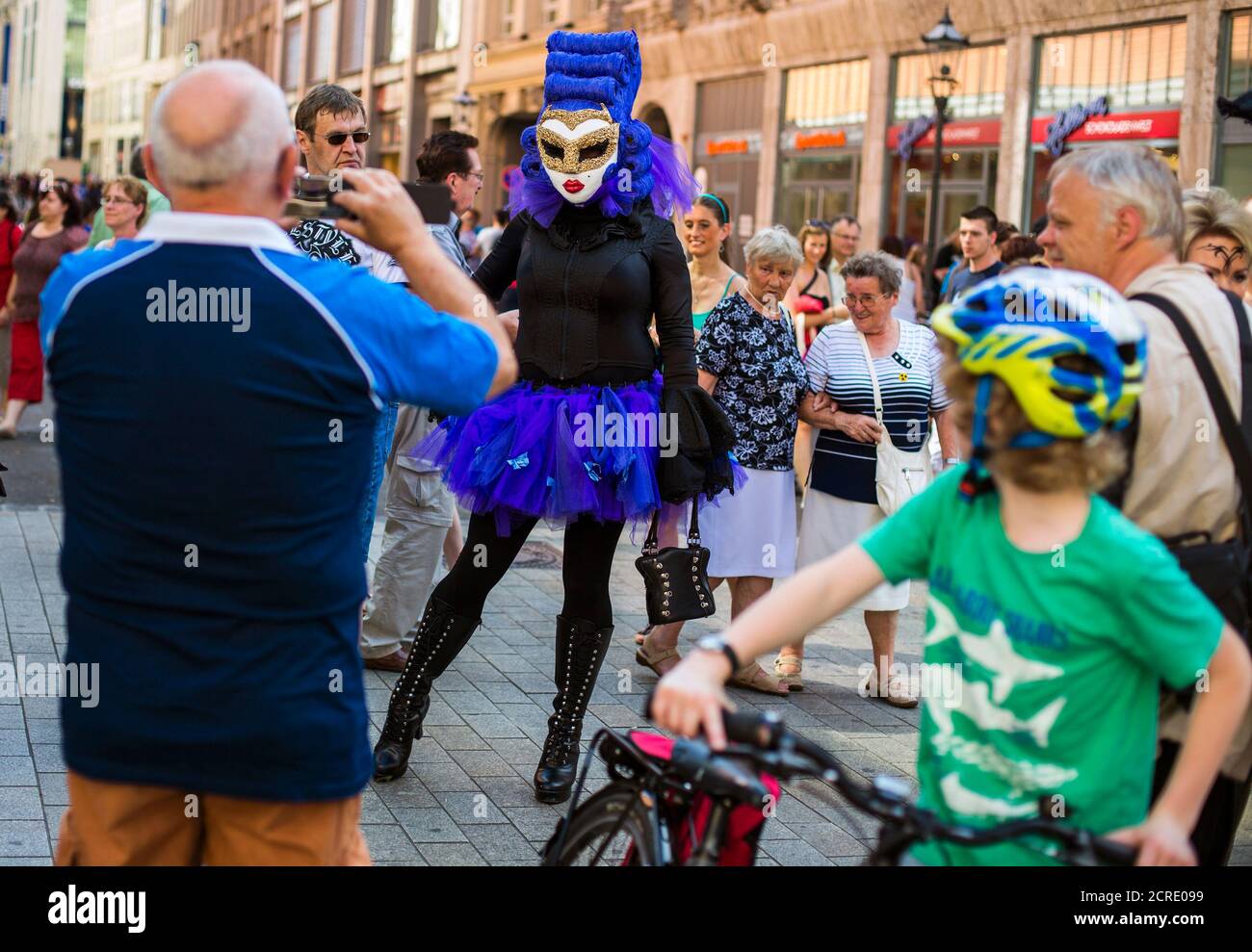 People take pictures of a reveller during the Wave and Goth festival in the  central shopping district of Leipzig June 7, 2014. The annual festival,  known in Germany as Wave-Gotik Treffen (WGT),