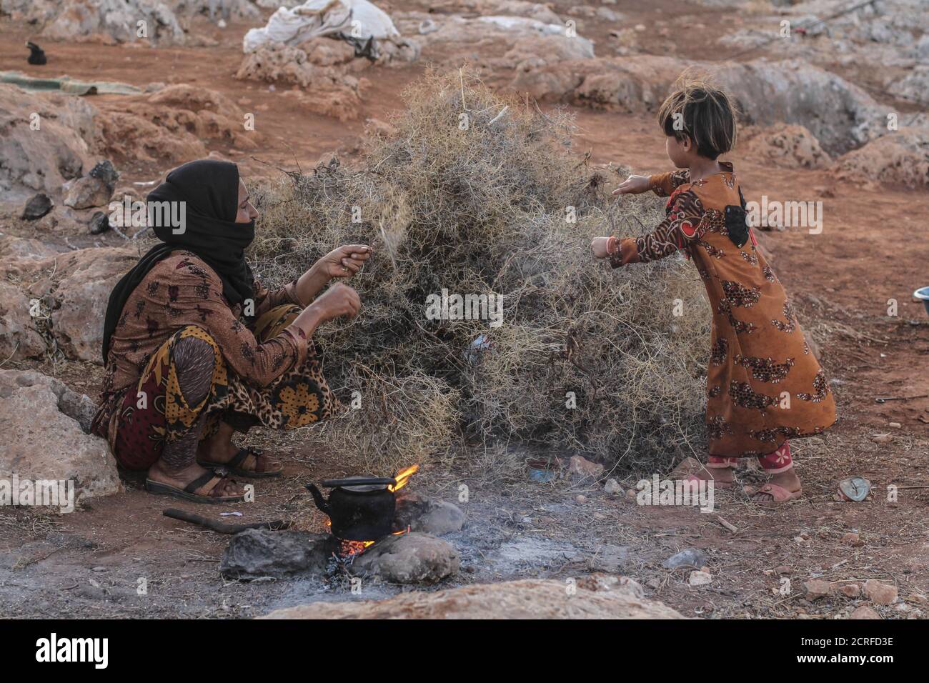 19 septembre 2020 : une femme prépare du thé sur bois de chauffage dans un camp dans le nord de la Syrie, et sa fille l'aide tout en cuisinant et en faisant bouillir le thé en raison du manque de gaz qu'elle a. Crédit : Moawia Atrash/ZUMA Wire/Alay Live News Banque D'Images