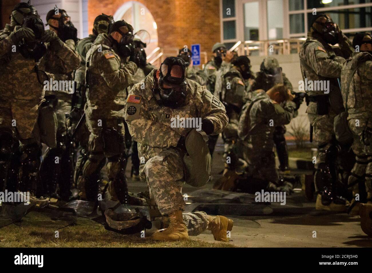 Members of the National Guard wear their gas masks during a protest outside  the Ferguson Police Station in Missouri, November 26, 2014. More than 2,000  National Guard troops spread out across the