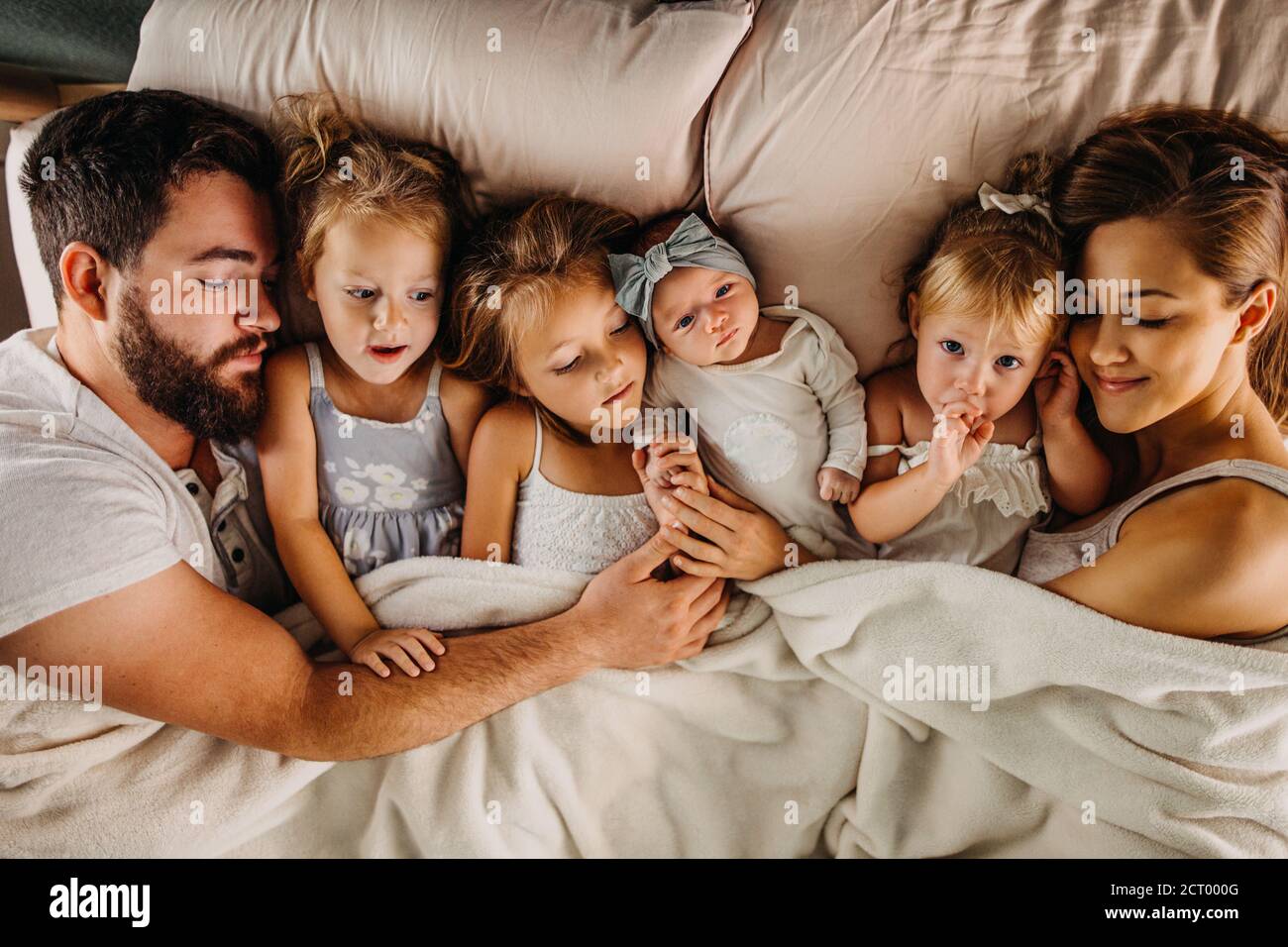 Grande famille, lit avec beaucoup d'enfants et tenant mains Photo Stock -  Alamy
