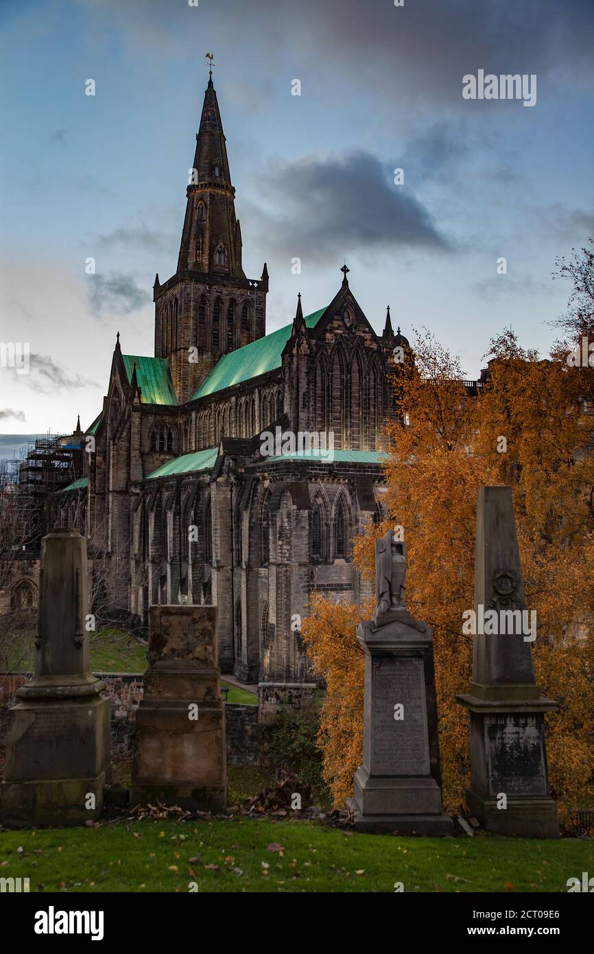 Glasgow / Écosse - 13 novembre 2013 : chute dans la ville. Cathédrale de Glasgow au coucher du soleil. Vue depuis la colline de la nécropole de Glasgow avec de graves monuments. Tons foncés. Banque D'Images