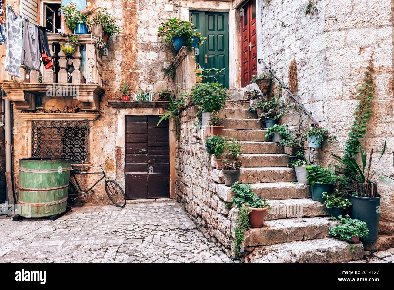 Rue pittoresque de la ville de Trogir avec pots de fleurs et frais blanchisserie Banque D'Images