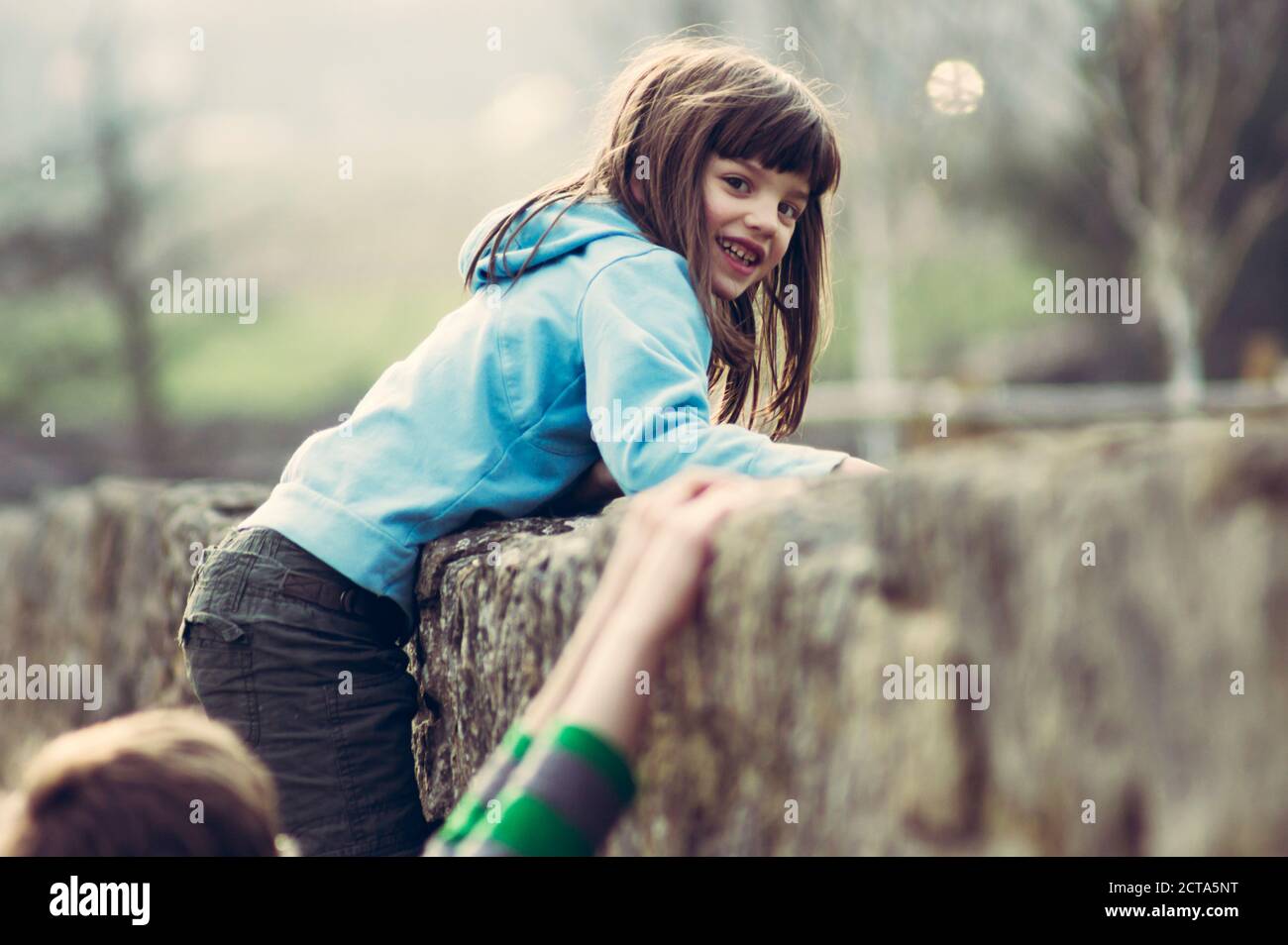 Portrait of Girl climbing on wall Banque D'Images