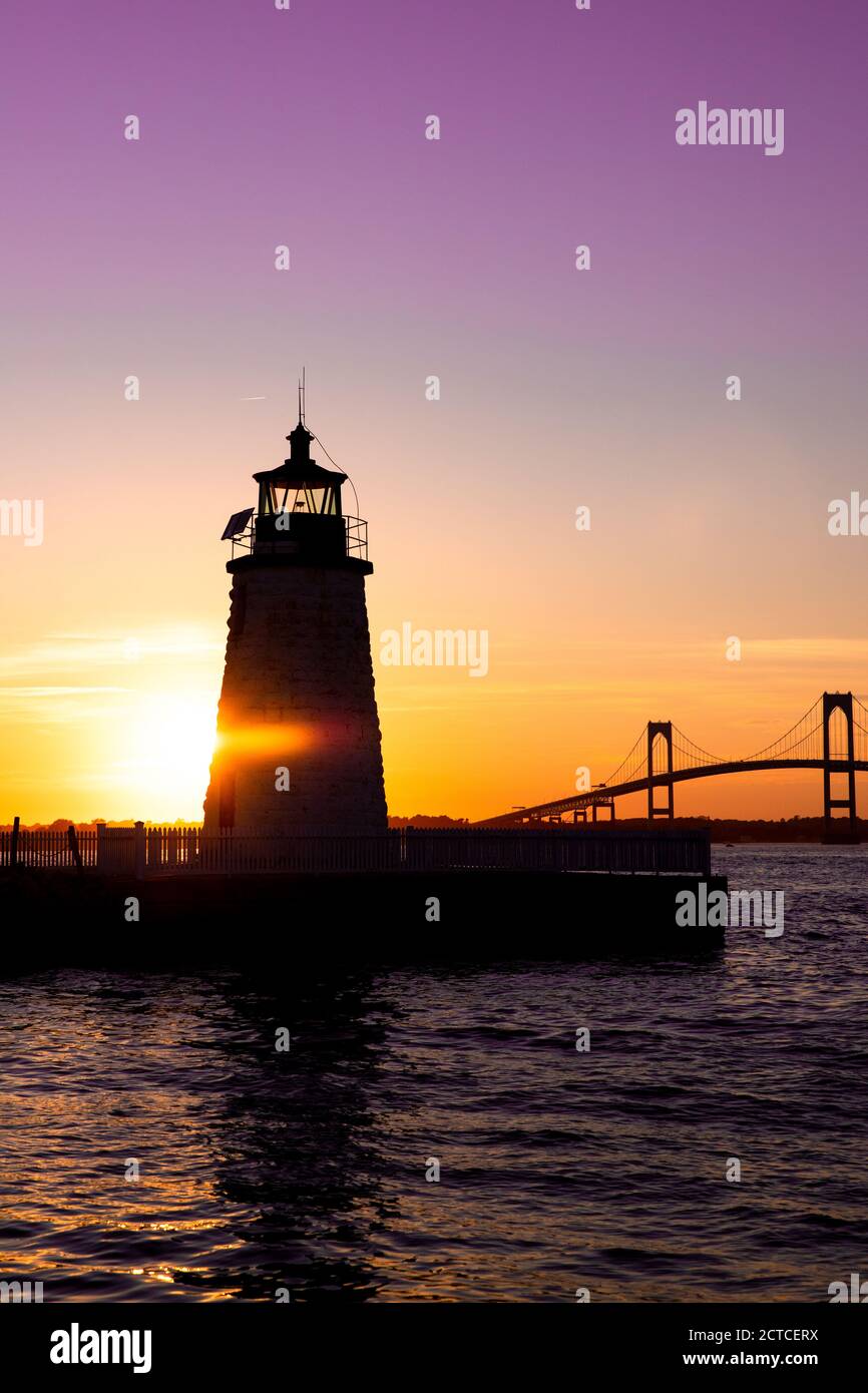 Coucher de soleil sur le phare de Newport Harbor avec pont et ciel coloré Banque D'Images