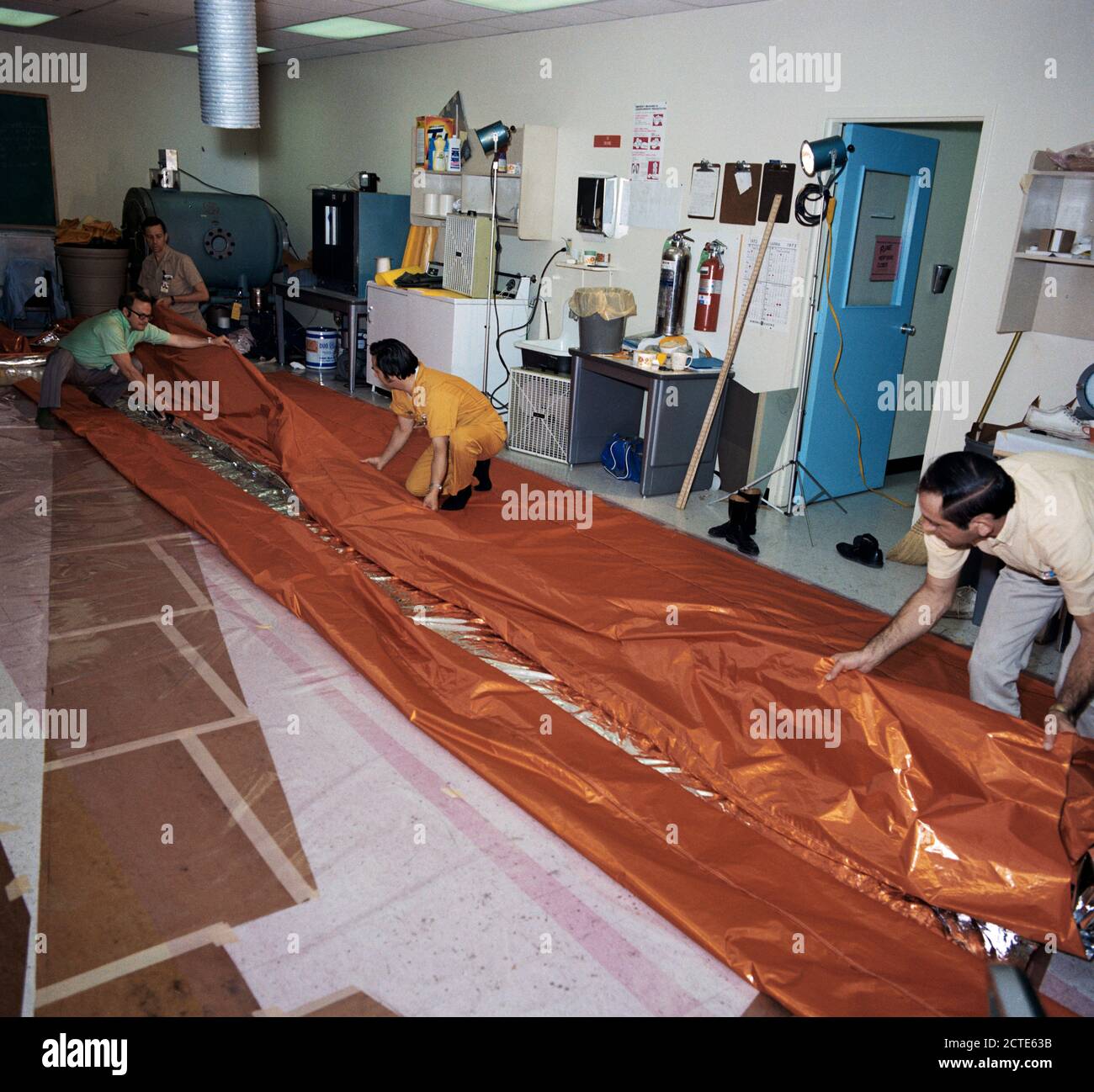 (18 mai 1973) --- ouvriers dans le GE Building en face du Centre spatial Johnson de plier un parasol en forme de voile cours de fabrication d'une utilisation possible comme un écran solaire pour l'atelier orbitale Skylab (OWS). Banque D'Images