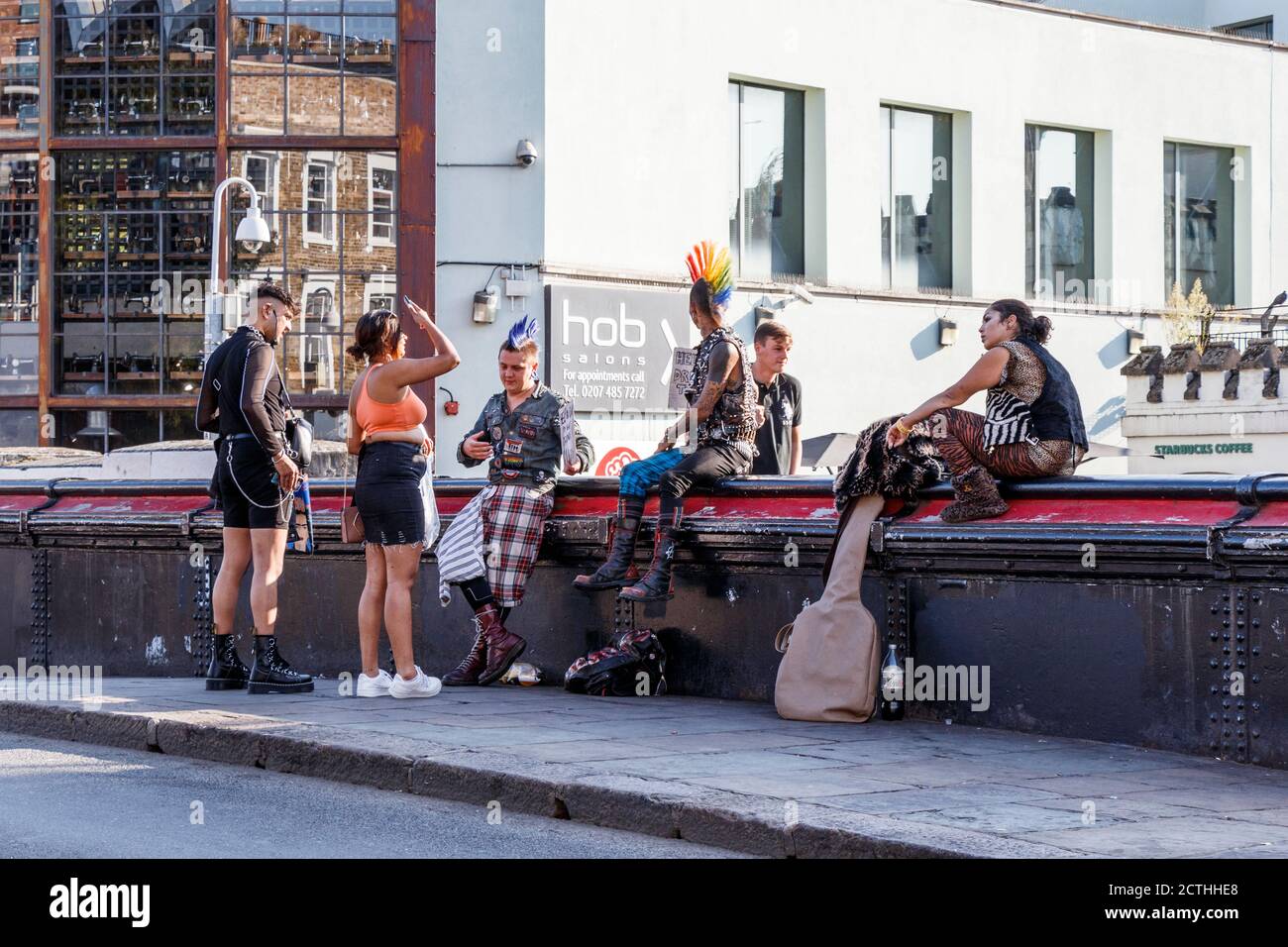 Un groupe de punks se sont présentés pour de la bière sur le pont au-dessus du canal Regent's à Camden Lock, dans un après-midi exceptionnellement chaud de la fin septembre, Londres, Royaume-Uni Banque D'Images