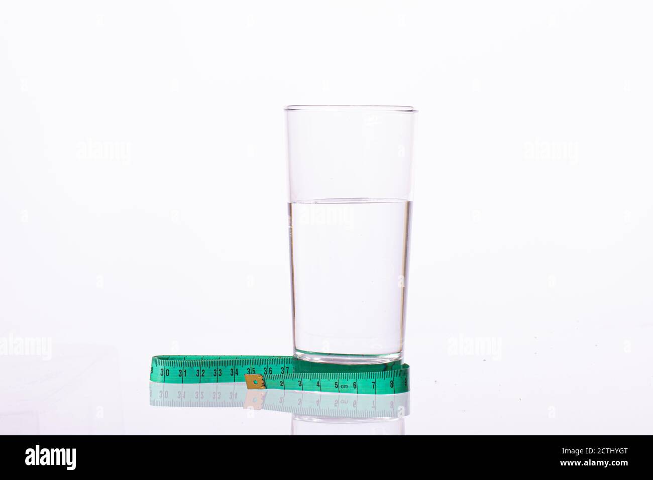 Verre d'eau pure attaché avec ruban de mesure vert isolé sur fond blanc  Photo Stock - Alamy