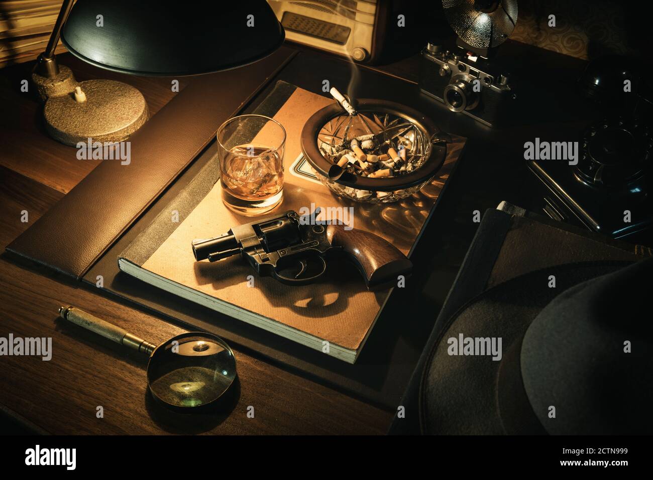 Film noir détective bureau avec revolver, whisky et cendrier, thriller et suspense concept Banque D'Images