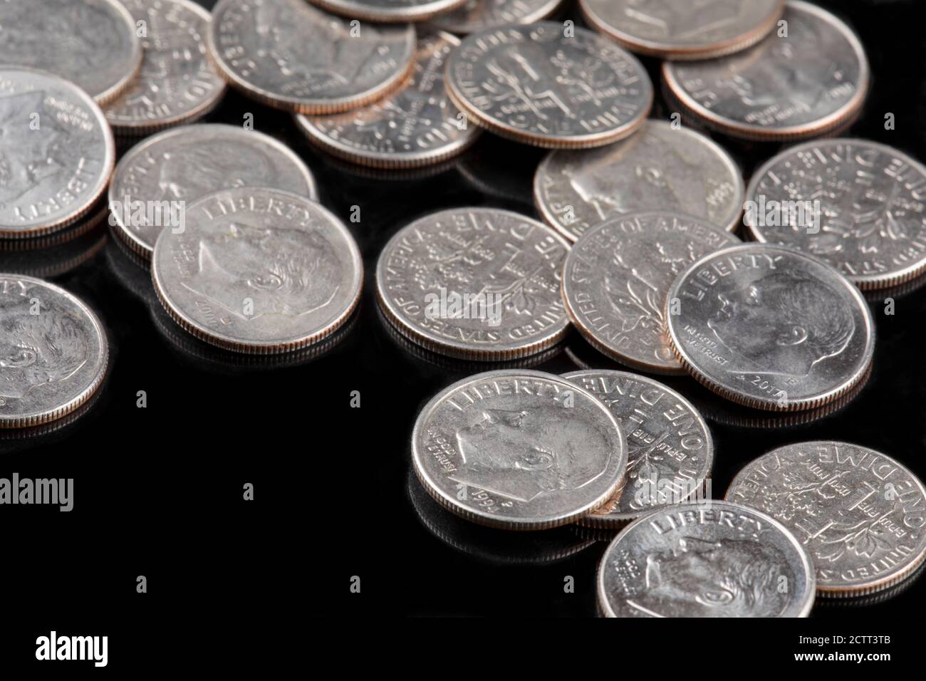 A Background of United States dime coins on black background Banque D'Images