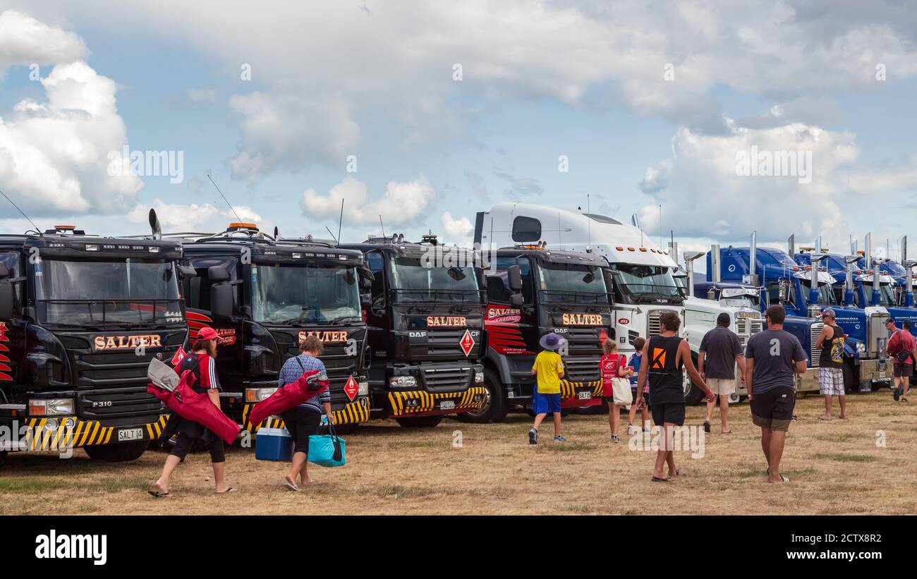 Les gens qui marchent devant une rangée de gros camions de rig de différentes marques et modèles lors d'un spectacle de camions. Mount Maunganui, Nouvelle-Zélande, janvier 18 2020 Banque D'Images