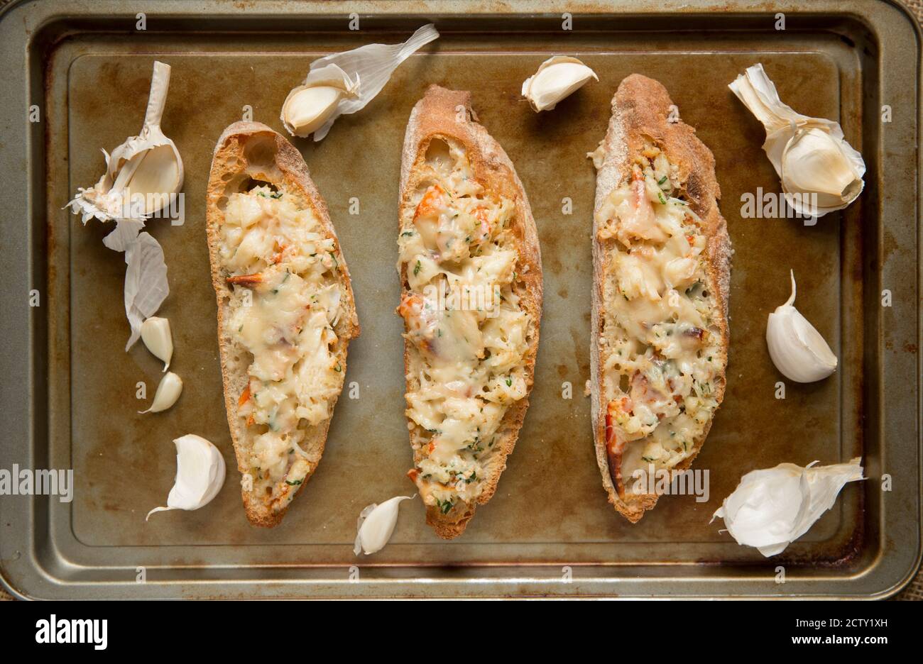 La viande de crabe blanc qui a été cuite avec du beurre, du persil et de l'ail, placée sur du pain de ciabatta grillé et grillée avec du parmesan. Dorset Angleterre Banque D'Images