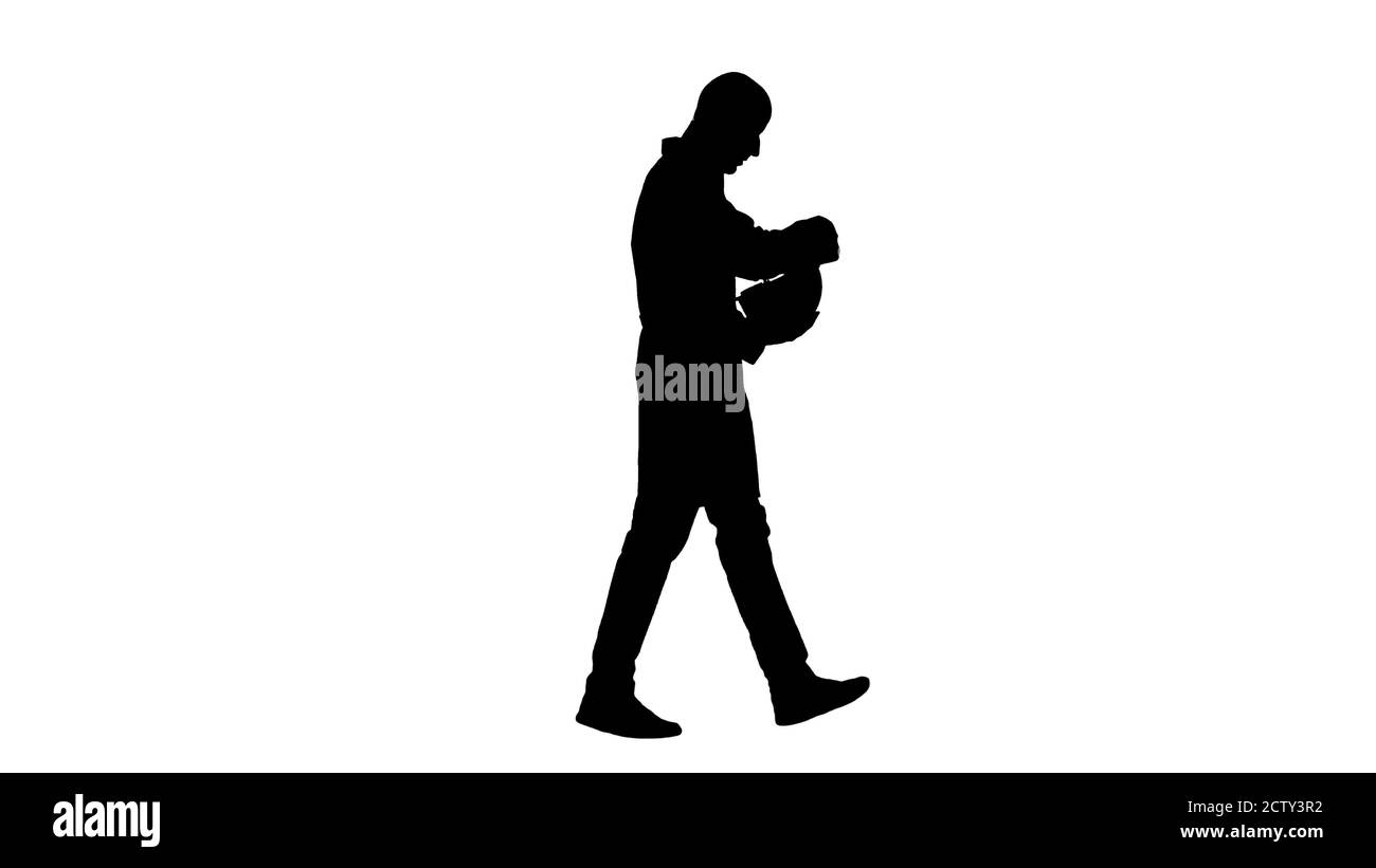 Silhouette Science ingénieur marchant et enfilant un casque. Concept de sécurité. Banque D'Images