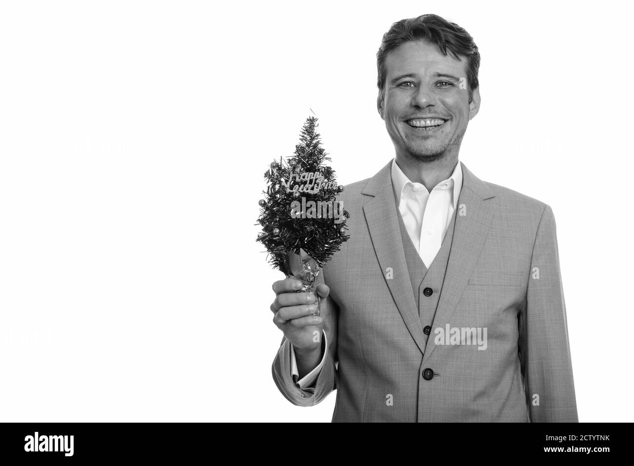 Happy Caucasian businessman holding Happy New Year tree Banque D'Images