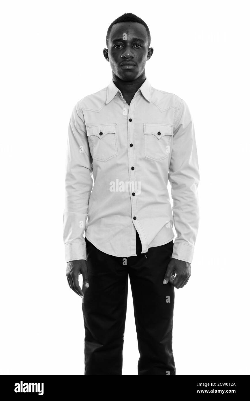 Studio shot of young black African man standing Banque D'Images Studio shot of young black African man standing Banque D'Images