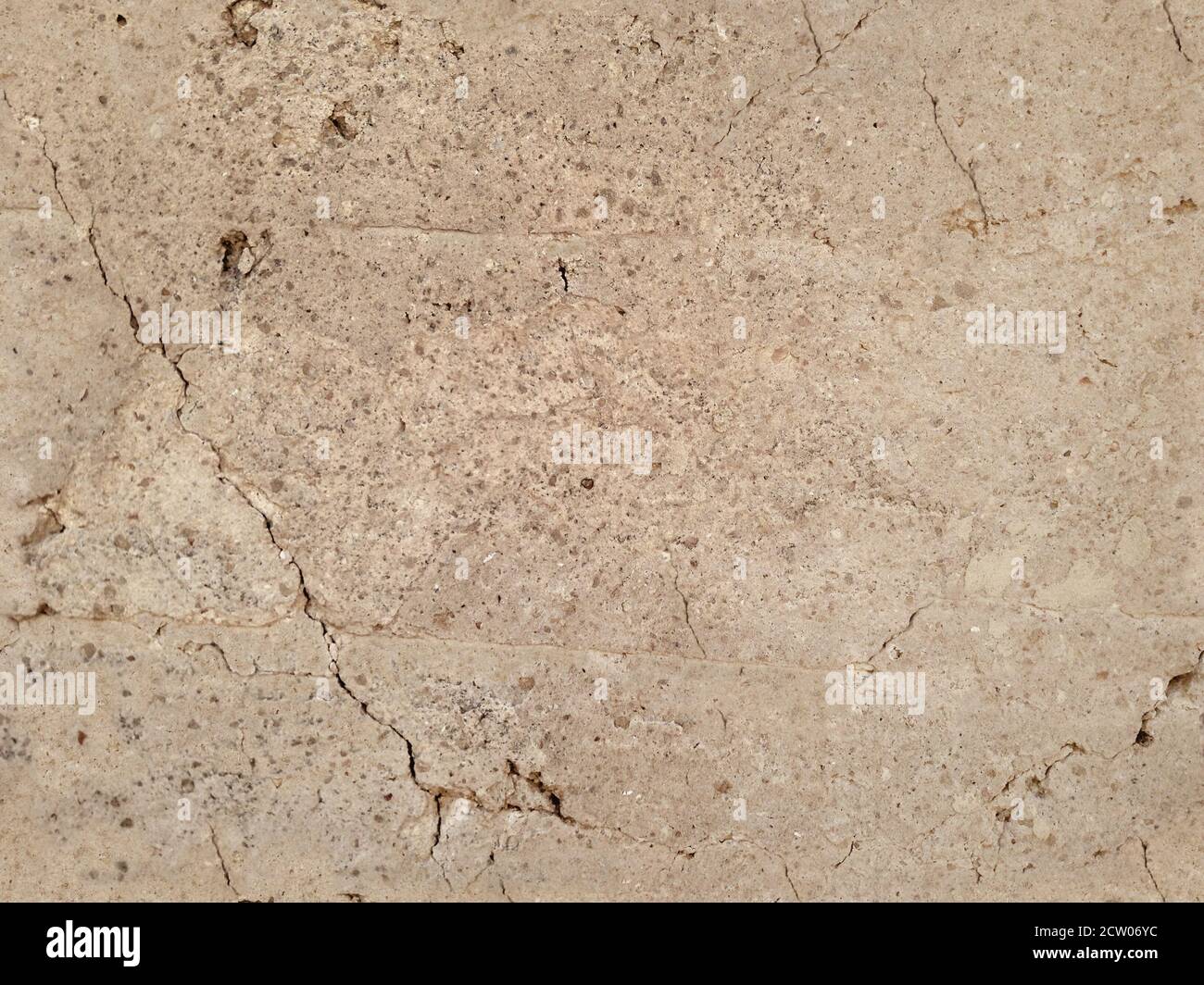 Texture sans couture avec un mur en adobe fissuré. Banque D'Images