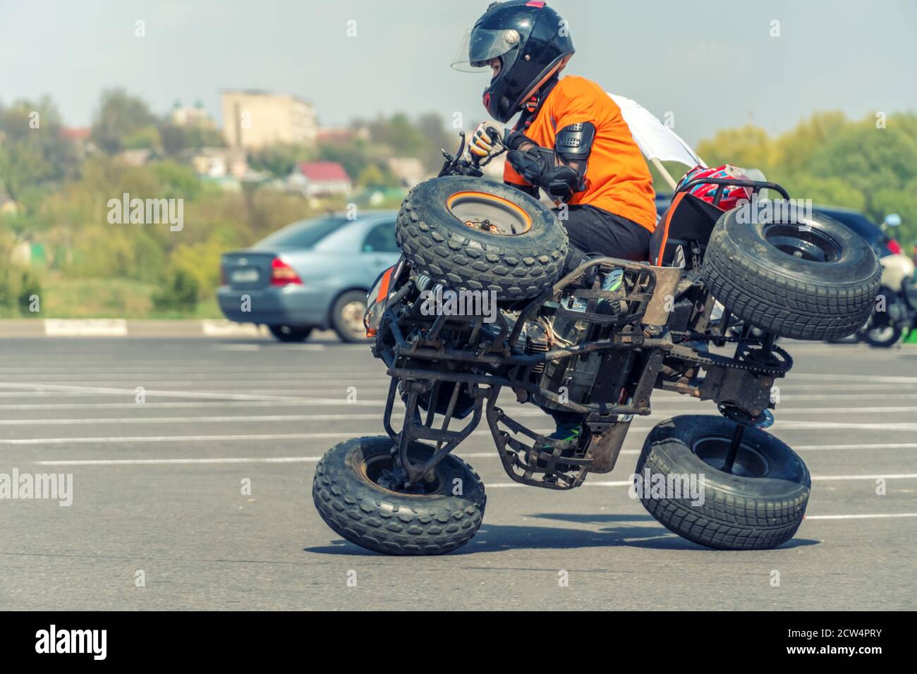 Acrobaties extrêmes sur un quad. Un adolescent fait des tours sur un Quad bike. Le Quad Bike est sur deux roues latérales. Banque D'Images