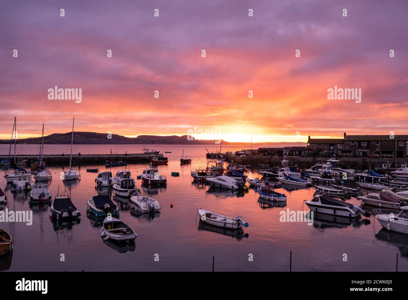 Lyme Regis, Dorset, Royaume-Uni. 28 septembre 2020. UK Météo: Le ciel brille avec la couleur de l'automne que le soleil se lève au-dessus de la Cobb, Lyme Regis sur un froid septembre matin. Credit: Celia McMahon/Alamy Live News Banque D'Images