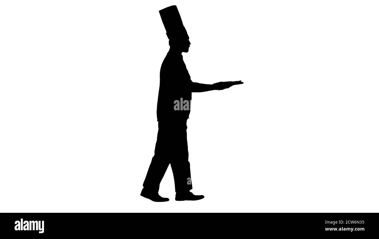 Silhouette Cook marchant dans une hâte avec une pizza dans ses mains. Banque D'Images