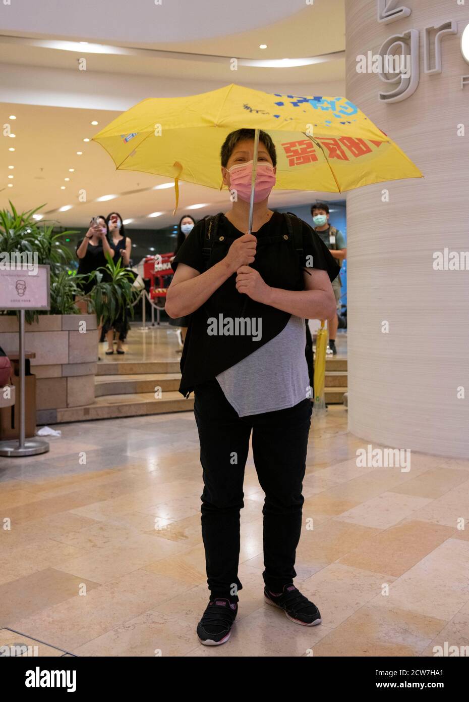 31 mai 2020, Hong Kong, Hong Kong, Chine : une dame lève un parapluie jaune et se tient en silence.a l'occasion du 6e anniversaire du mouvement des parapluies, seul un très petit nombre de personnes ont choisi de protester. L'introduction de la loi sur la sécurité nationale a créé une atmosphère de peur réduisant les activités de protestation. Ceux qui souhaitent protester se sont rassemblés dans le Pacific place Mall plutôt que par les bureaux du gouvernement à Admiralty. La police arrive et kettle presse et les acheteurs menant à des arrestations. (Image de crédit : © Jayne Russell/ZUMA Wire) Banque D'Images