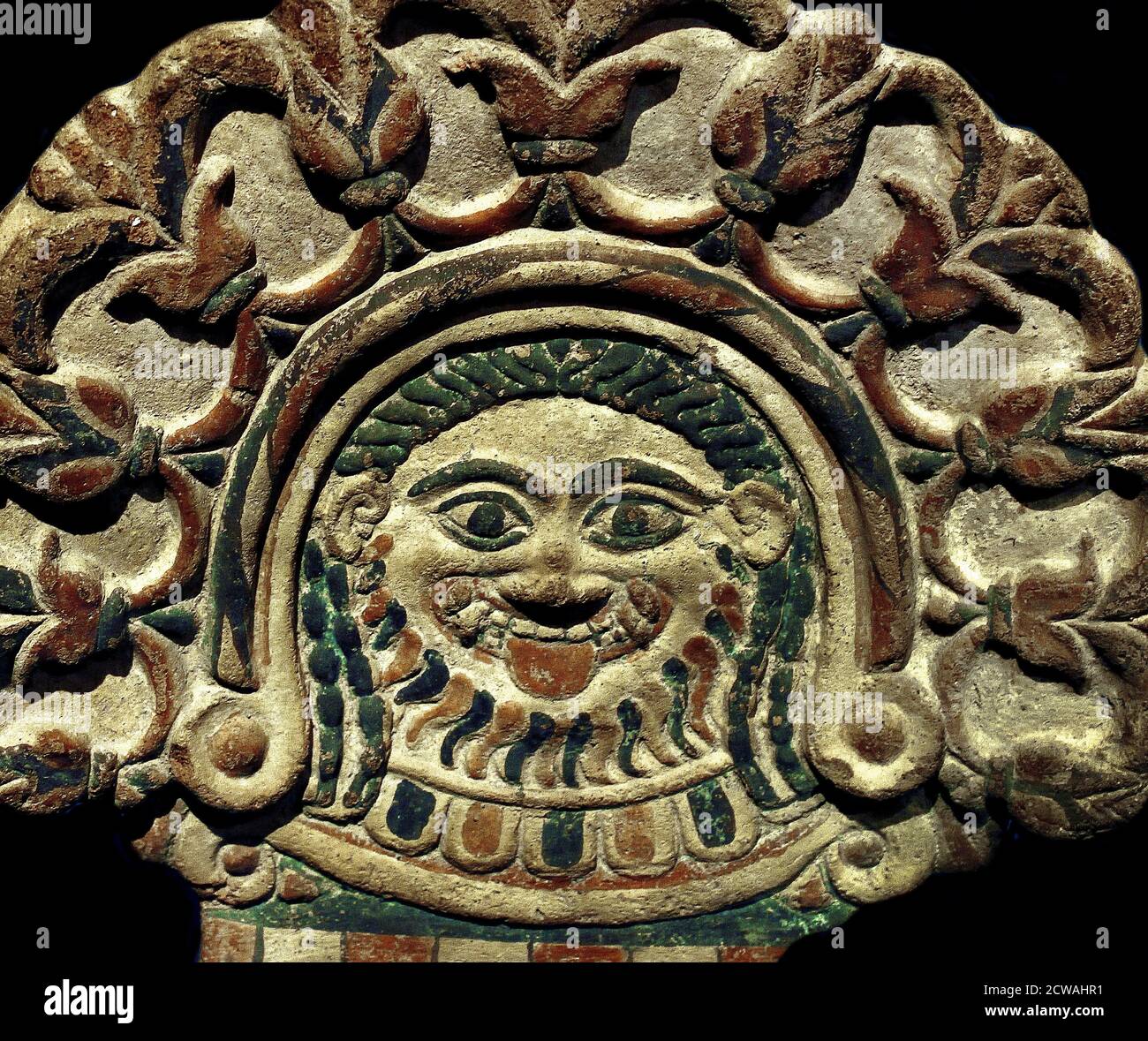 Une antefix en terre cuite avec un Gorgoneion entouré de fleurs de lotus. De l'Italie. Vers 540 av. J.-C. ( la Medusa grecque ressemble à BES parce qu'elle colle sa langue; elle est également souvent combinée avec des serpents dangereux. ) Banque D'Images