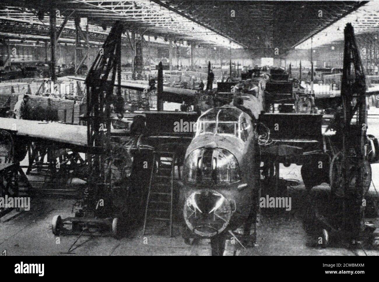 Photographie en noir et blanc de l'Angleterre au travail malgré les raids de bombardement allemands pendant la bataille d'Angleterre pendant la Seconde Guerre mondiale (1939-1945); une femme arpente la côte tout en étant garde debout. Banque D'Images