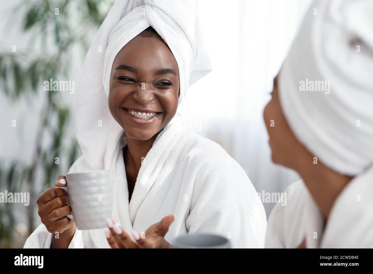 Deux jeunes femmes africaines plaisantant en buvant du thé Banque D'Images