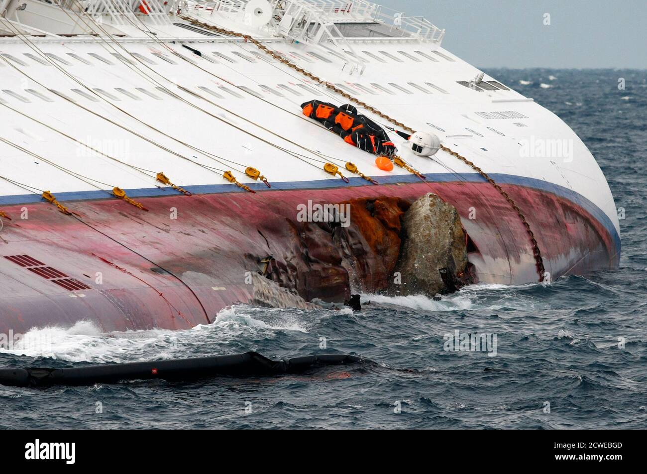 A Weather Damaged Oil Boom Floats Near A Breach In The Hull Of The Cruise Liner Costa Concordia Off The West Coast Of Italy At Giglio Island February 2 2012 Royal Caribbean Cruises